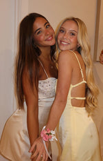Close-up of the cream sequin bust of a mini dress with thin spaghetti straps and a satin-like skirt