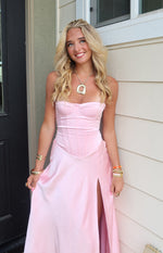 Pink satin strapless corset maxi dress showing the structured bodice and high thigh slit