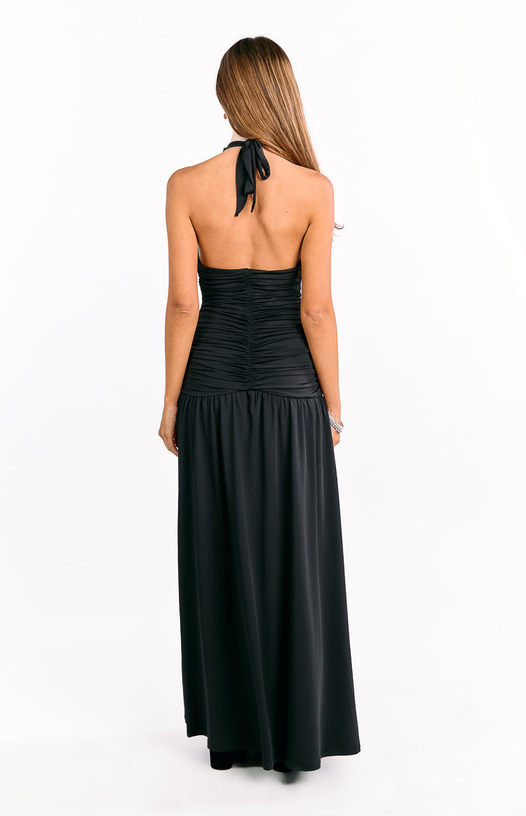 Rear view of a black halter neck maxi dress with a tie-back and ruched bodice