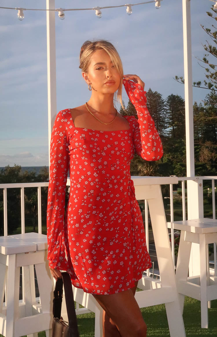 Red floral long sleeve mini dress with a square neckline and visible side tie detail