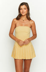 Front view of a yellow strapless mini dress with a fitted bodice and pleated pleated mini skirt