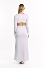 Rear view of a white long sleeve maxi dress with a lower back cutout and ruched skirt detail