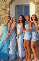 Side view of a light blue satin mini dress with thin spaghetti straps and a ruched bust