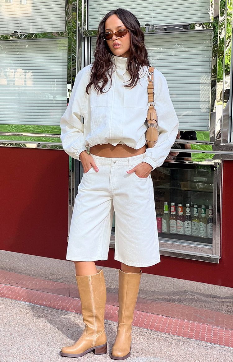 Front view of white denim shorts with a relaxed wide-leg fit and visible front pockets