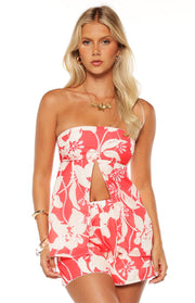 Front view of a red and white floral strapless longline top with a split front detail