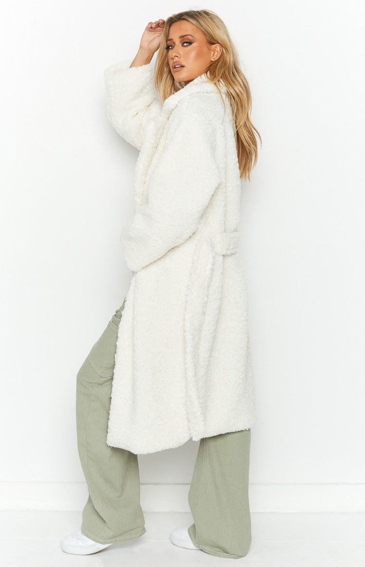 Front view of an open white teddy coat with wide lapels and a relaxed, longline fit
