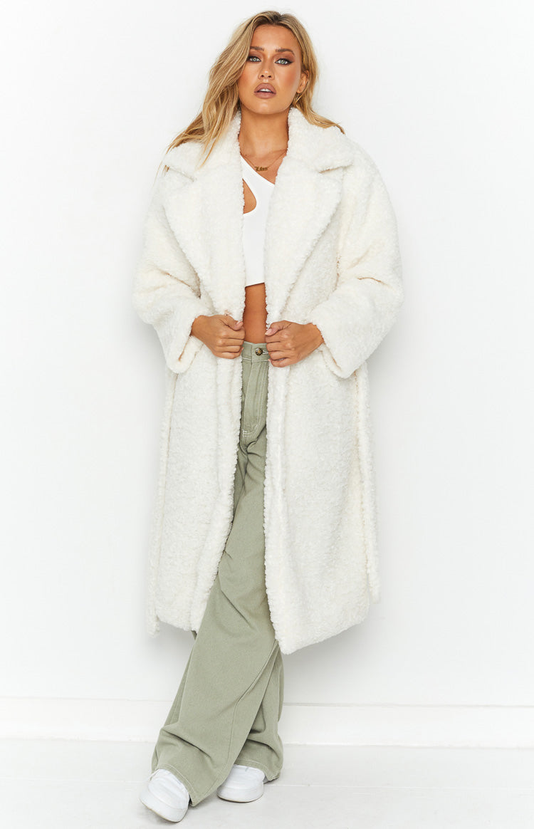 Front view of an open white teddy coat with wide lapels and a soft, textured fabric