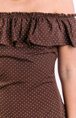 Detail of the brown polka dot mini dress showing the elasticated off-shoulder ruffle