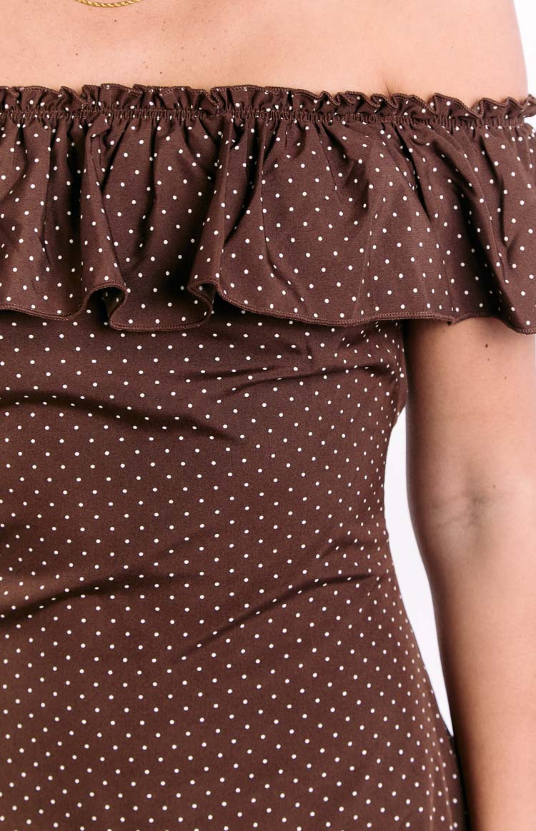 Detail of the brown polka dot mini dress showing the elasticated off-shoulder ruffle