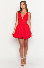 Red mini dress with a deep V-neck, ruched fitted waist, and voluminous bubble hem