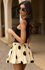 Beginning Boutique Henrietta Yellow Polka Dot Bubble Hem Mini Skirt yellow with black polka dots, ruched elastic waist and bubble hem