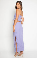 Side view of a purple crinkled maxi skirt with a high side split
