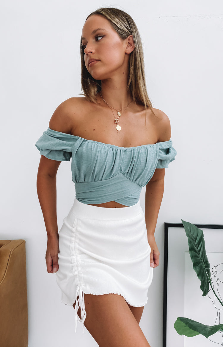 Sage off-the-shoulder crop top featuring a ruched sweetheart neckline and wrap hem