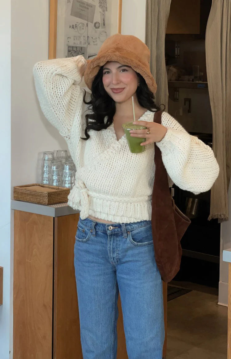 Front view of the cream chunky knit wrap cardigan with a deep V-neck and a tie closure at the waist