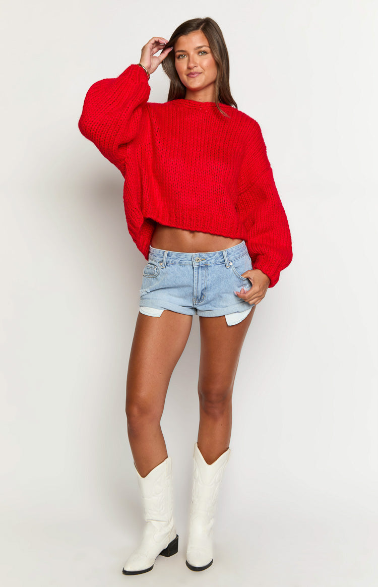 Full front view of a red chunky knit cardigan with an oversized cropped fit and long balloon sleeves