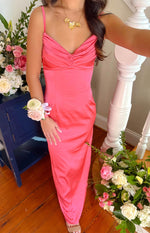 Close-up of the ruched sweetheart neckline and fitted bodice of a honey pink maxi dress