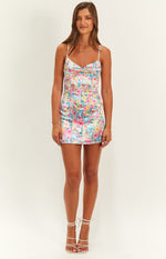 Front view of a honey pink floral print mini dress with a ruched sweetheart neckline and thin spaghetti straps