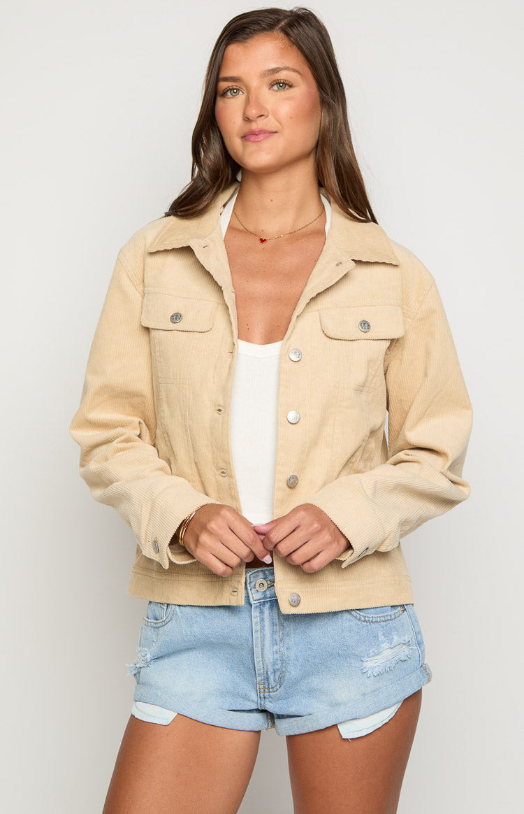 Cream corduroy western jacket with a classic collar, silver snap buttons, and two chest pockets