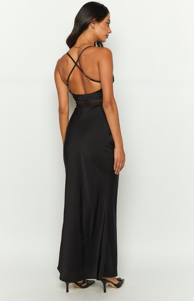 Rear close-up of the black maxi dress featuring a deep V-neckline and a patterned lace panel across the back