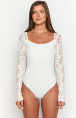 White bodysuit with a square neckline and long sheer floral lace sleeves