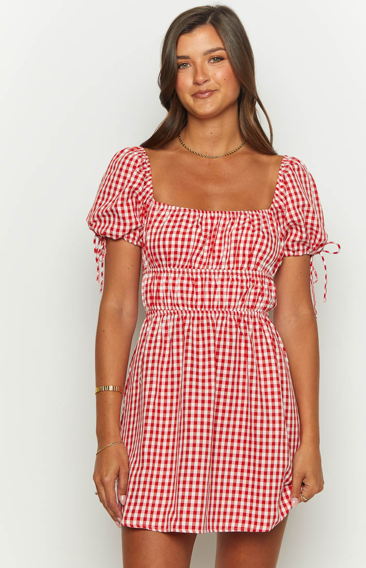 Red gingham mini dress with a square neckline, shirred bodice, puff sleeves with tie details, and A-line skirt