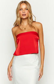 Close-up front view of a red satin strapless top with a straight neckline and a subtle flared hem