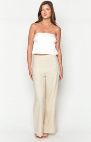 Front view of a white satin strapless crop top with a slight flared hem