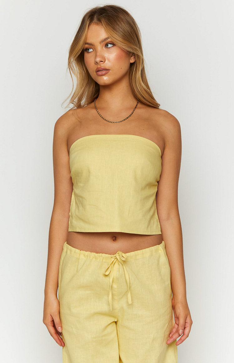 Front view of a yellow linen-blend strapless crop top with a relaxed fit and visible fabric texture
