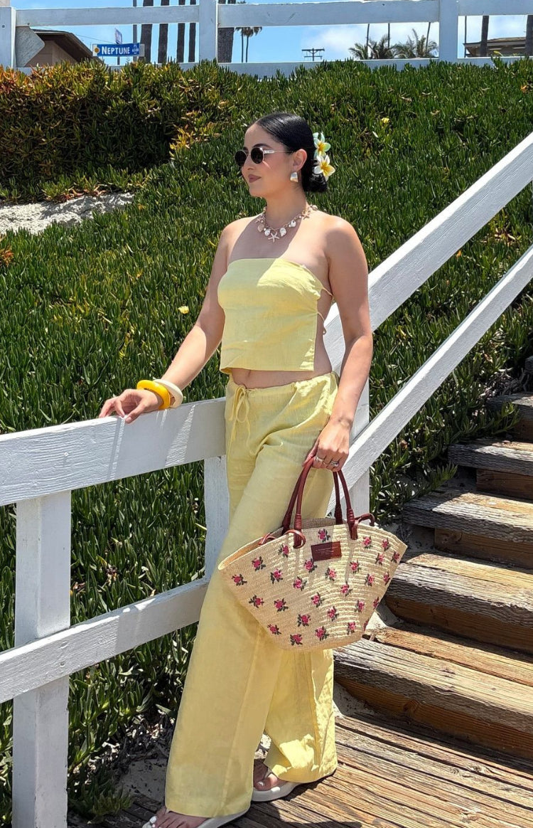 Yellow strapless crop top with a relaxed fit and visible side tie detail in a linen-look fabric
