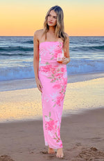 Full length view of a pink strapless maxi dress with ruched bodice and green and pink floral print