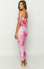 Side view of the bodycon pink and white tie-dye print strapless maxi dress with a ribbed texture and raw hem