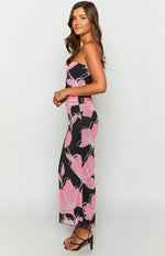 Side view of a black and pink floral strapless maxi dress with ruched waist detail and bodycon fit