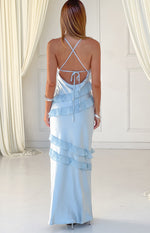 Rear view of a light blue maxi dress with criss-cross tie-back spaghetti straps and tiered horizontal ruffles