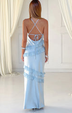 Rear view of a light blue maxi dress with criss-cross tie-back spaghetti straps and tiered horizontal ruffles