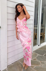 Side view of a pink floral print maxi dress showing side cutouts, tiered ruffles, and tie-back detail