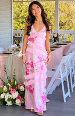 Side view of a pink floral print maxi dress with tiered ruffles and criss-cross back straps