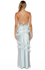 Rear view of a light blue satin maxi dress with criss-cross spaghetti straps, a tie-back, and tiered ruffles
