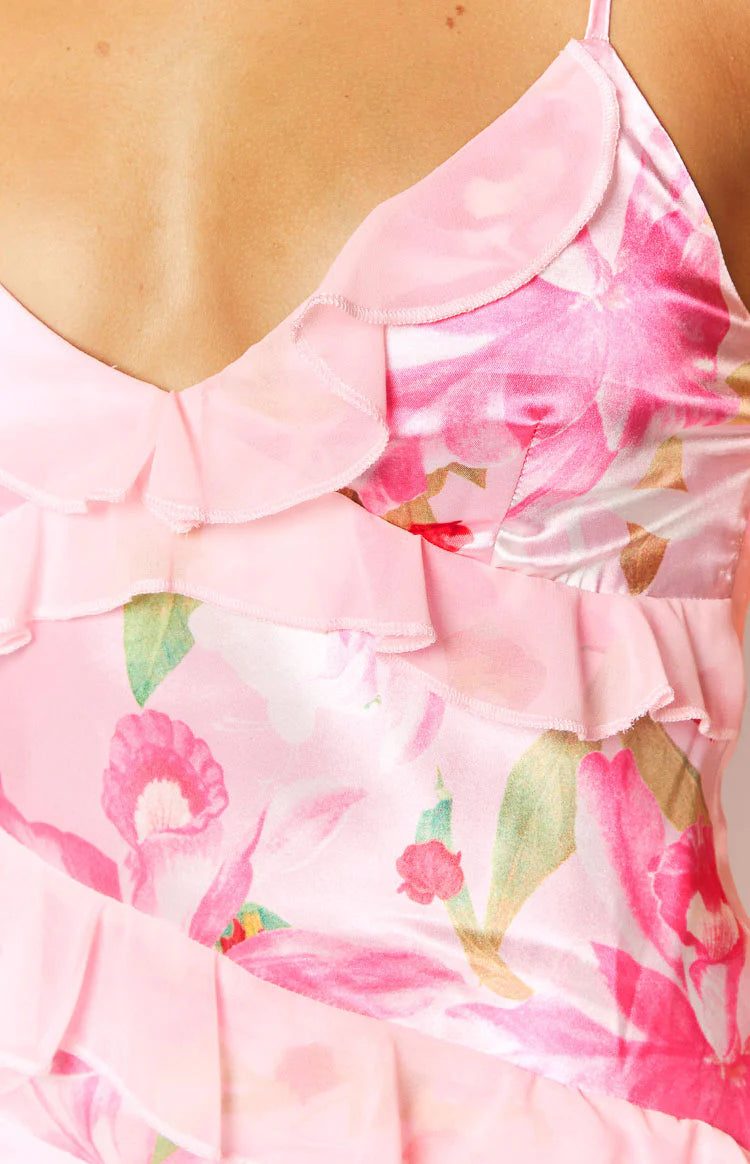 Full length front view of a pink floral print satin maxi dress with a ruffled V-neck and tiered ruffles