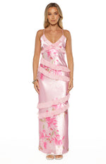 Side view of a pink floral print satin maxi dress with tiered ruffles and spaghetti straps