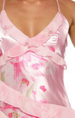 Rear view in mirror showing criss-cross tie-back straps on a pink floral ruffle maxi dress