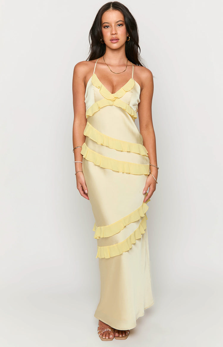 Pale yellow satin maxi dress with a V-neck, spaghetti straps, and cascading sheer yellow ruffles