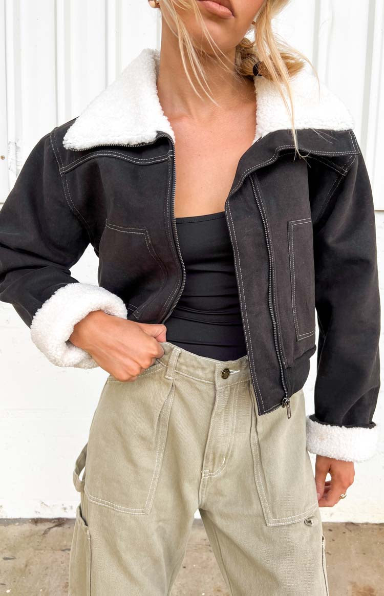Black denim cropped jacket with white sherpa collar and cuffs, open front showing white contrast stitching