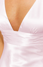 Close-up of the V-neckline and ruched bust detail on the pink satin mini dress