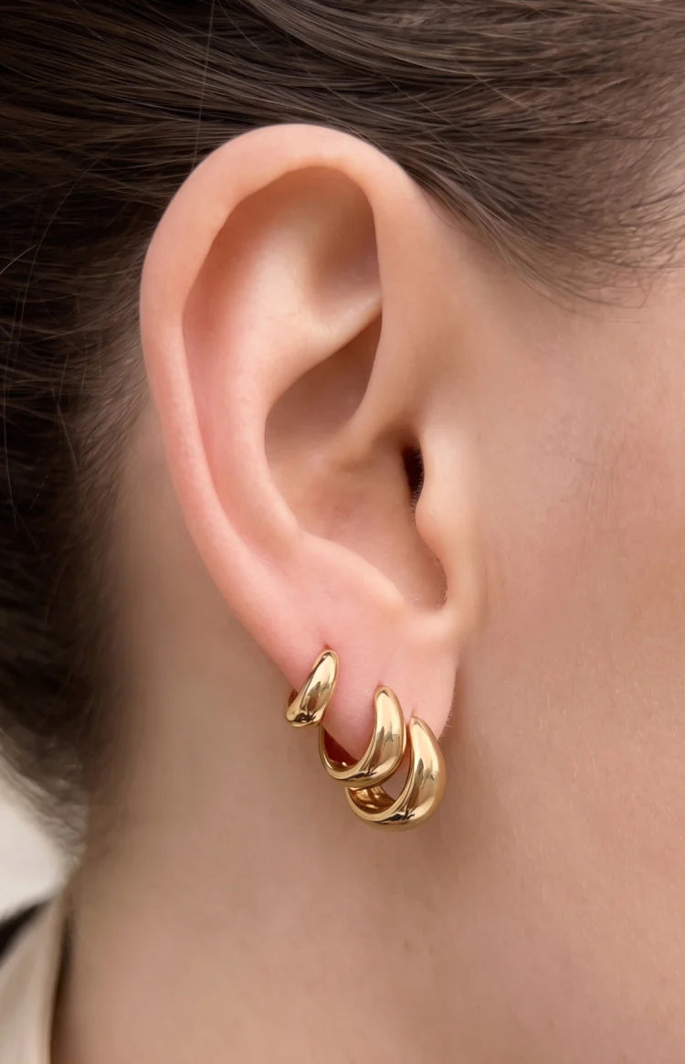 Beginning Boutique Isolde Gold Three Piece Huggie Earring Set three gold thick rounded huggie earrings in varying sizes