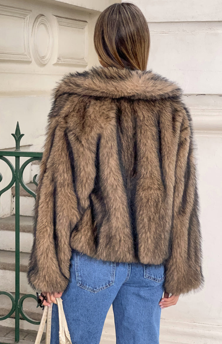 Rear view of a chocolate brown faux fur jacket with a wide collar and cropped length