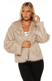 Sand faux fur jacket with wide lapels and an open front, showing its cropped length and shaggy texture