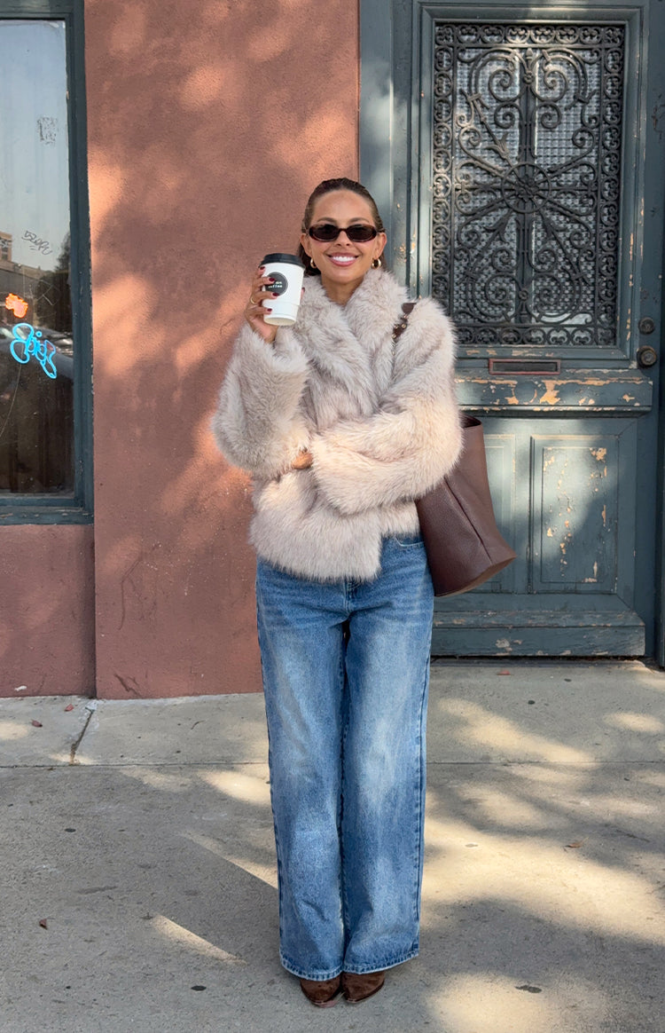 Sand faux fur jacket with a wide collar, cropped length, and shaggy texture