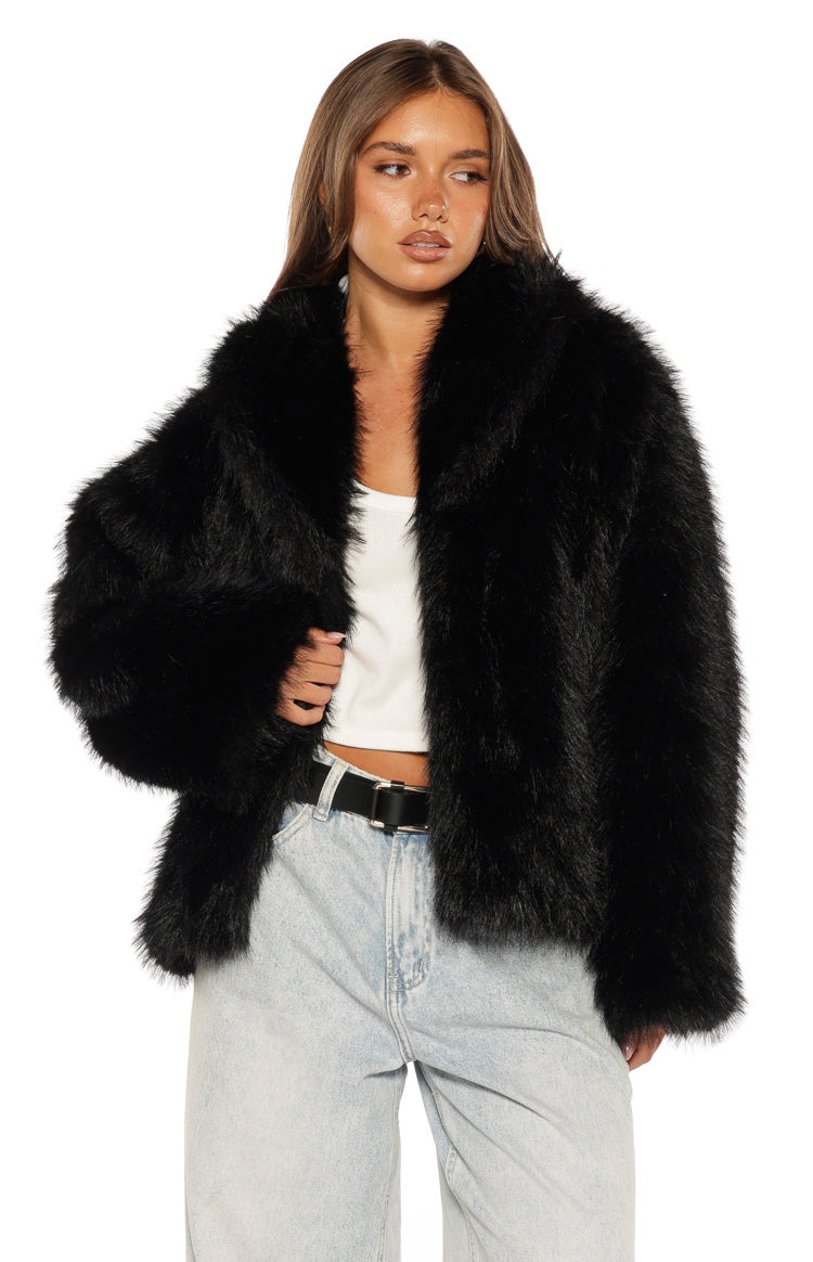 Black faux fur jacket with wide lapels, open front, and relaxed fit, showing the fluffy texture