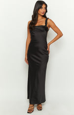 Black satin maxi dress with a square neckline, thin ruffled straps, and a fitted silhouette