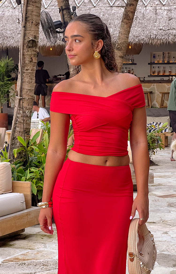 Fitted red maxi skirt with subtle vertical ruching detail on the side